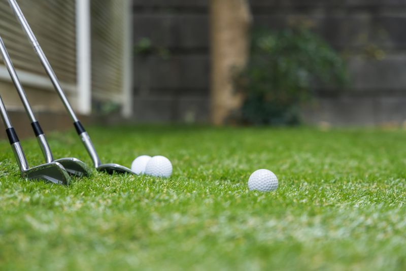 golf clubs and balls, synthetic grass putting greens