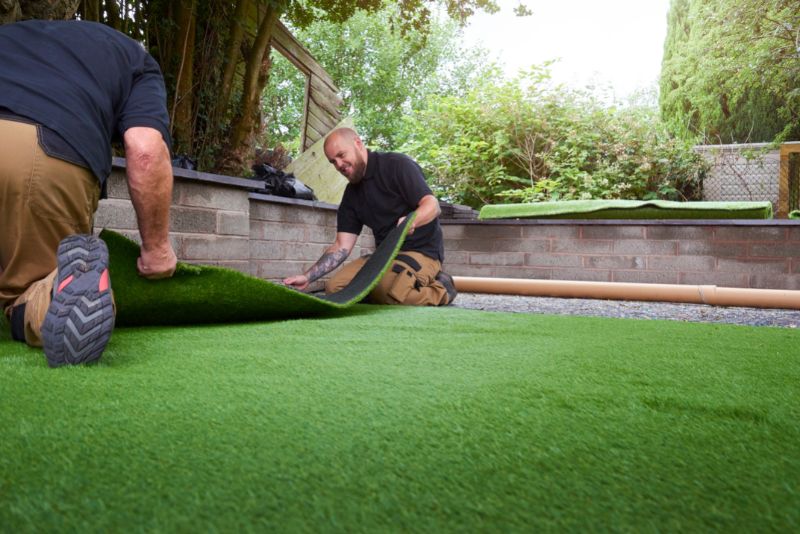 two men installing artificial grass