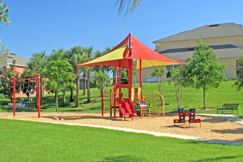 kids playground with a synthetic grass lawn